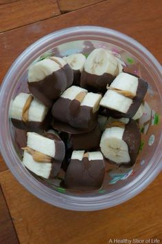 a plastic bowl filled with chocolate covered bananas