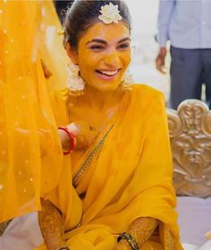 a woman with yellow paint on her face