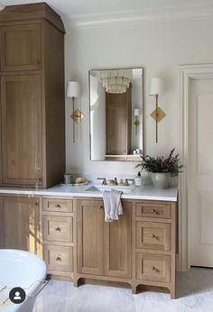 a bathroom with two sinks and a bathtub next to it's doors open