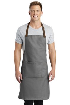 a man wearing an apron and smiling at the camera with his hands in his pockets