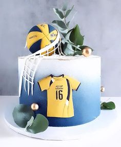 there is a cake decorated to look like a soccer jersey and ball on top of it