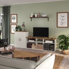 a living room filled with furniture and a flat screen tv on top of a wooden shelf