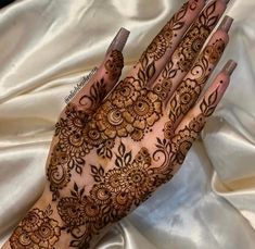 a woman's hand with henna on it