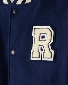 Our iconic Vintage Varsity Jacket, for kids. Inspired by our classic collegiate aesthetic, this handmade piece will never go out of style. Designed and handcrafted in Canada in our factory in Toronto Snap front closure Leather trimmed pockets Ribbed collar, cuffs and waistband Chenille crests on front chest, sleeve and back Fully lined with a custom all-over-print lining MATERIALS Body: melton wool blend – 80% wool, 20% nylon Sleeves and pocket trim: 100% leather Body Lining: 100% polyester Sleeve Lining: 100% viscose LOOK AFTER ME Dry clean only | Roots Kids Vintage Varsity Jacket 2.0 inch Navy Collegiate Outerwear With Ribbed Cuffs For School, Classic Navy Varsity Jacket For College, Classic College Varsity Jacket With Contrast Collar, Classic Varsity Jacket With Contrast Collar For College, Classic College Outerwear With Embroidered Logo, Classic Navy Varsity Jacket With Ribbed Cuffs, Collegiate Aesthetic, Vintage Varsity Jacket, Vintage Varsity