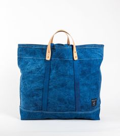 The Large East West Tote is perfect for grocery runs or weekend getaways, and it's washable. It effortlessly transforms from a handheld to a shoulder bag with detachable leather handles, making it washable too. (check the care instructions below, wink!). Crafted from Dark Indigo canvas, dyed by a family of textile artists in Western India, it undergoes a meticulous process of hand-dipping into a natural indigo vat up to 20 times to achieve the perfect shade of dark blue. Everyday Coated Canvas Bag With Reinforced Handles, Coated Canvas Bag With Reinforced Handles For Everyday Use, Rectangular Weekender Bag With Reinforced Handles, Everyday Shoulder Bag With Reinforced Handles In Coated Canvas, Waxed Canvas Tote Bags With Reinforced Handles, Everyday Blue Canvas Bag With Reinforced Handles, Daily Use Waxed Canvas Shoulder Bag With Reinforced Handles, Everyday Travel Bag With Reinforced Double Handles, Everyday Travel Bag With Double Reinforced Handles