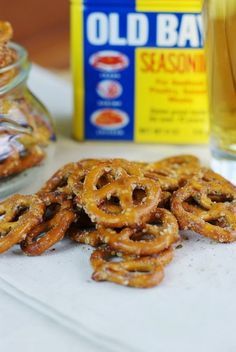 some pretzels are sitting on a table next to a jar of honey syrup