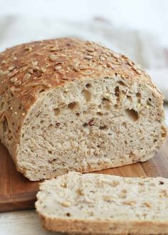 a loaf of bread sitting on top of a wooden cutting board