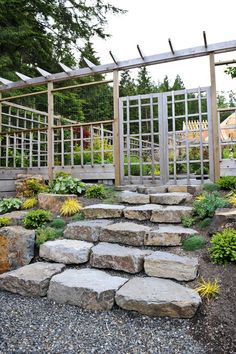 an outdoor garden with stone steps and trelliss