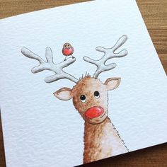 a drawing of a deer with antlers on it's head and a red nose