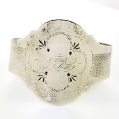 "Description: An antique silver cuff bracelet with embossed and hand engraved embellishments. The front has and engraved monogram NYL. Unmarked but tested to be at least coin silver which is 900 silver. The opening is flexible and easy to put on and remove. The shape can be adjusted for any size wrist by your local jeweler for a final fit. Circa 1850's - 1870's. Weighs 15.2 grams. Measurements: The inside diameter measures 2\" at the widest and fits on a average sized wrist. Condition: Good with Engraved Cuff, Antique Coins, Wire Bangles, Curved Wedding Band, Stacked Bangles, Sterling Silver Filigree, Hinged Bangle, Silver Filigree, Silver Cuff Bracelet