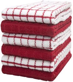 four red and white towels stacked on top of each other