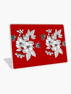 a red laptop with white flowers on it