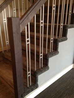 an image of a stair case with carpet on the bottom and handrails up