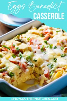 a casserole dish with cheese and vegetables in it on a blue platter