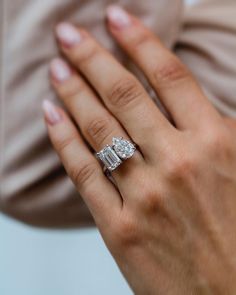 a woman's hand with a diamond ring on it