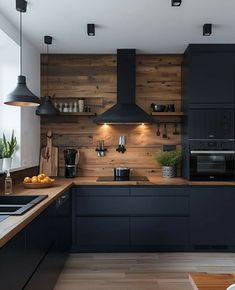 a kitchen with wooden walls and black cabinets is pictured in this image, there are lights on above the counter