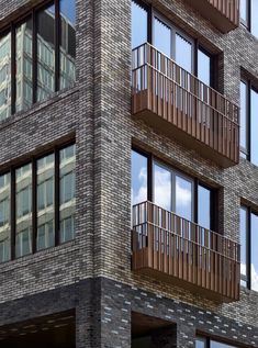 a tall brick building with balconies and windows