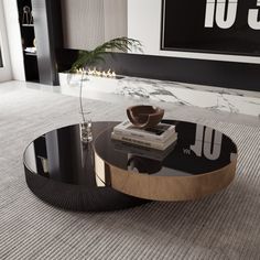 a black and gold coffee table with books on it in a living room area next to a plant