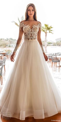 a woman in a wedding dress standing on a wooden floor with palm trees behind her