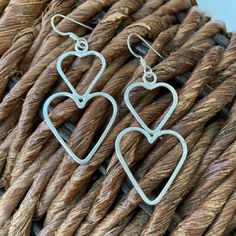 Connected hearts are solid sterling silver, hand fabricated.  They are solid but lightweight to wear all day.   The perfect gift for Mother's Day, birthdays or whatever special occasion you're celebrating. 2-1/4 inches from the bend in the ear wire.   will arrive in a tarnish retardant bag in a box ready for gift giving.  Need more than one pair?  message me. Connected Hearts, Sterling Silver Heart Earrings, Silver Heart Earrings, Sterling Silver Heart, Ear Wire, Heart Earrings, Silver Heart, Mother Day Gifts, Sterling Silber