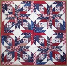 a red, white and blue quilt with stars on the center is shown in this image