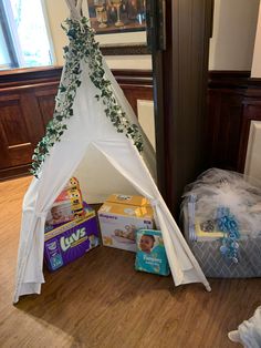 a teepee is sitting on the floor next to boxes