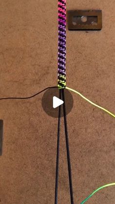 a video demonstrating how to make a string art sculpture with colored yarn and plastic straws