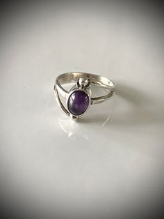 This vintage sterling silver and amethyst ring is perfect for any vintage jewelry enthusiast! Delicate and beautiful and the cabochon stone is secure in its setting. Measures about 5 1/2-5 3/4 abs is a lovely little treasure! Thanks guys looking and please check out my shop for more wearable heirloom quality vintage jewelry! Polished Vintage Amethyst Ring, Vintage Amethyst Jewelry With Polished Finish, Collectible Oval Cabochon Amethyst Ring, Vintage Amethyst Rings With Polished Finish, Vintage Purple Amethyst Ring With Polished Finish, Vintage Amethyst Oval Cabochon Ring, Vintage Amethyst Ring With Polished Finish, Vintage Amethyst Birthstone Ring With Gemstone, Purple Oval Cabochon Hallmarked Ring