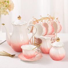 pink and white porcelain tea set with gold accents