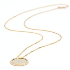 Elevate your style with our 14K solid gold Mirror Disc Diamond Necklace, a harmonious blend of elegance and refinement. The mirror-like disc pendant, crafted in lustrous gold, is framed by a satin-finish beaded design that adds texture and sophistication. Adorned with a sparkling 0.02-carat ideal round brilliant-cut diamond, this necklace measures 7/8" in length, making it the perfect accessory for special occasions or everyday luxury. Embrace timeless charm with this captivating piece. Elegant Medallion Necklace With Delicate Chain, Elegant Coin Necklace With Delicate Chain, Elegant Jewelry With Delicate Chain And Round Disc, Yellow Gold Necklaces With Satellite Chain, Elegant Yellow Gold Medallion Necklace With Oval Pendant, Elegant Gold Medallion Necklace With Polished Finish, Elegant 14k Gold Medallion Necklace, Elegant Yellow Gold Oval Medallion Necklace, Elegant Everyday Medallion Necklace