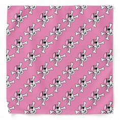 a pink bandanna with skulls and bones on it