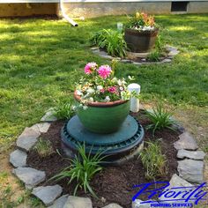 a potted planter sitting on top of a garden bed in the middle of a yard