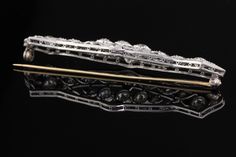 A stunning platinum and diamond bar brooch from the Edwardian era with beautiful and delicate milgraining. Item #JP-P0007 Metal: Platinum Weight: 12 Grams Diamond Weight: Approximately 3.50 cts Diamond Color: H Diamond Clarity: VS2 Measurements: 17 x 66 mm Layaway: For your convenience, we will be happy to provide layaway payment options. Please contact us to work out a layaway plan which best suits your needs. All layaway purchases are final sale. All domestic and international shipments are sh Classic Evening Brooches With Diamond Accents, Elegant Formal Brooches With Rose Cut Diamonds, Classic White Gold Brooches With Single Cut Diamonds, Elegant Rose Cut Diamond Brooches For Formal Occasions, Elegant Formal Brooches With Single Cut Diamonds, Classic Platinum Brooches, Elegant Platinum Brooches With Diamond Accents, Classic Brooches With Rose Cut Diamonds, Classic Platinum Brooches With Diamond Accents