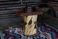 a wooden table with a bowl on top of it in a room filled with wood planks