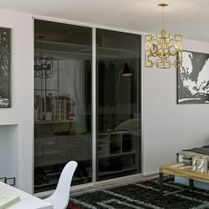 a living room filled with furniture and a fire place next to a wall mounted tv