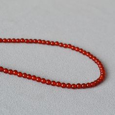 Material: Agate Fashion Element: Round Style: Ethnic Style Red Agate Beaded Necklaces With Round Beads, Red Carnelian Round Bead Jewelry, Red Agate Beaded Necklace With Gemstone Beads, Red Agate Beaded Necklaces, Red Beaded Necklaces With Natural Stones, Red Crystal Necklaces With Gemstone Beads, Agate Crystal Necklaces With Polished Round Beads, Red Necklaces With Natural Stone Round Beads, Red Necklaces With Natural Stones And Round Beads