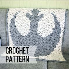 a crocheted star wars blanket sitting on top of a couch