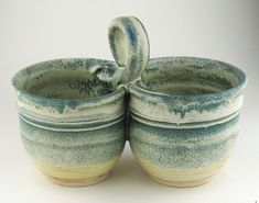 two ceramic bowls sitting next to each other