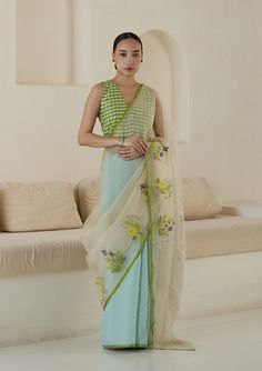 In the serene hue of seafoam, the Adore Jamdani saree is a testament to beauty in simplicity. Handwoven from the finest organza mulberry silk, its texture is as enchanting as its color, draping you in artistry. The allure unfolds on the contrasting beige organza pallu, adorned with delicate floral jamdani bunches.Jamda Cocktail Saree, Saree Floral, Sari Dress, Saree For Women, Dress Embroidery, Indian Dresses Traditional, Jamdani Saree, Black Saree, Saree Trends