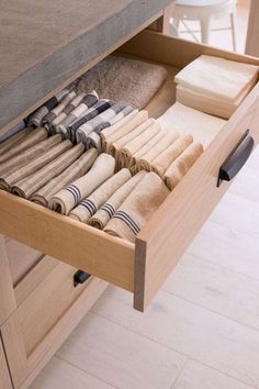 an open drawer with folded towels in it