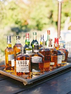 several bottles of liquor are lined up on a tray