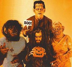 three people dressed up as zombies holding pumpkins with boo written on them and one man wearing a striped shirt