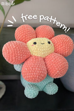 a crocheted stuffed flower with the words free pattern on it and a plant in the background