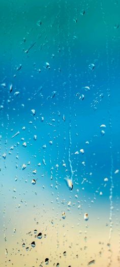 rain drops on the window with blue sky in background