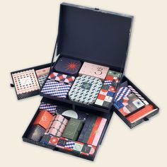 an open suitcase filled with assorted ties and matching pocket watches on top of each other