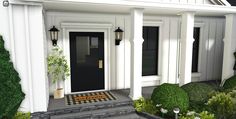 a white house with black doors and checkerboard flooring on the front steps