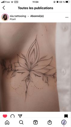 the back of a woman's stomach with a flower tattoo design on it,