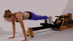 a woman doing push ups on an exercise machine