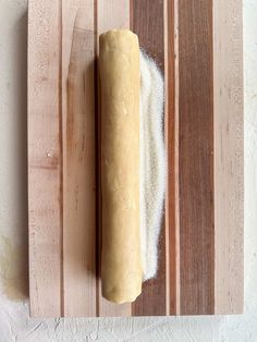 a loaf of bread sitting on top of a cutting board next to a rolling pin