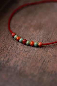 This unique choker necklace was made of red-pink, orange, green, red ceramic beads, red cowhide leather cord with copper end clasps, copper lobster claw and chain. Perfect for everyday wear! The length of necklace is about 43.5cm or 17.1 inches and 3 cm of adjustable length chain. Other necklaces you can find in my store in the necklace section. https://www.etsy.com/shop/NaTavelli?section_id=14843046&ref=shopsection_leftnav_5 Thanks for a visit. Casual Wooden Beads Jewelry As Gift, Casual Wooden Beaded Jewelry Gift, Casual Handmade Round Necklace, Bohemian Beaded Necklaces With Spacer Beads, Bohemian Jewelry With Tiny Round Beads, Bohemian Round Beads For Gifts, Bohemian Beaded Necklaces With Tiny Beads, Bohemian Beaded Necklace With Tiny Beads, Bohemian Round Beaded Necklace With Tiny Beads